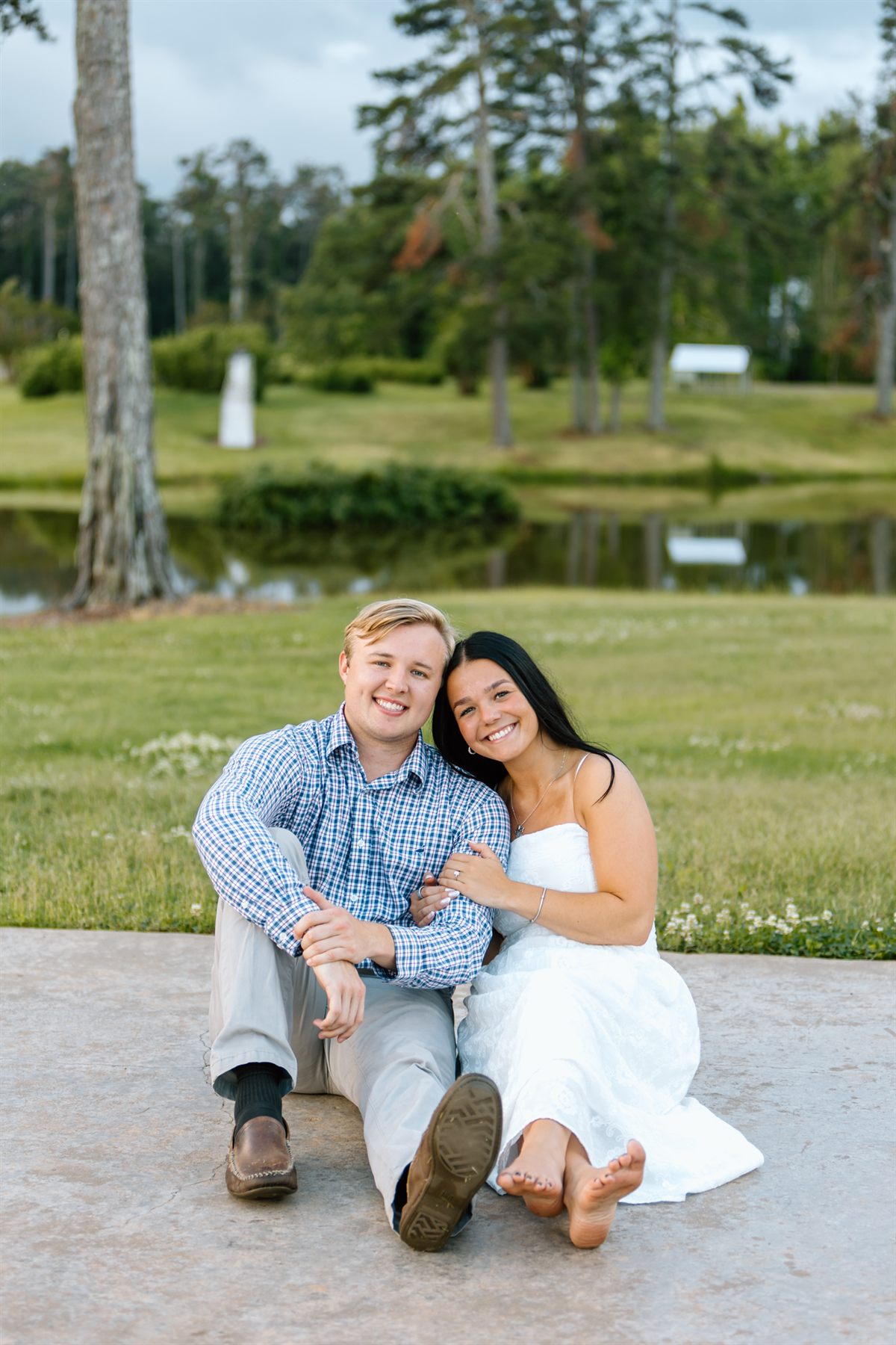Bailey and Maria sitting together by the pond